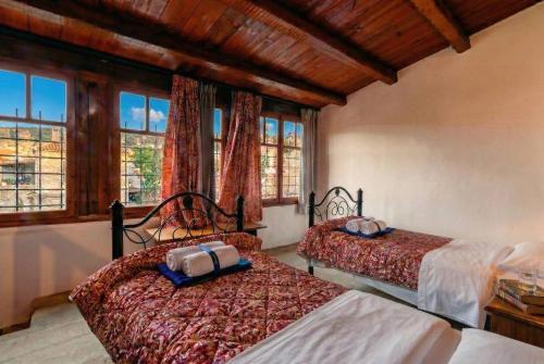 a bedroom with two beds and windows in a room at Elounda Collection Villa in Vrouchas