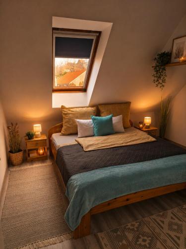 a bedroom with a large bed with a window at Várfal apartman I in Eger