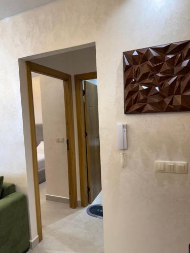 a living room with a mirror and a green couch at اقامة هبة 1 in Yebha