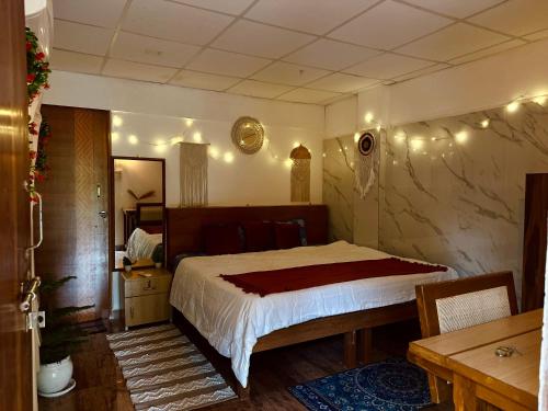 a bedroom with a large bed with lights on the wall at The Nivasa Project in Agonda