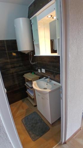 a bathroom with a sink and a mirror at Durmitor Holiday in Žabljak