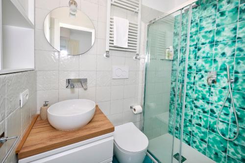 a bathroom with a sink and a glass shower at La Marilena Penthouse in Capri