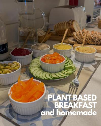 a table topped with bowls of different types of vegetables at Casa Caravan - Plant Based Concept House in Buenos Aires