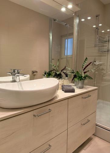 a bathroom with a sink and a mirror at Apartment Francos in Primošten
