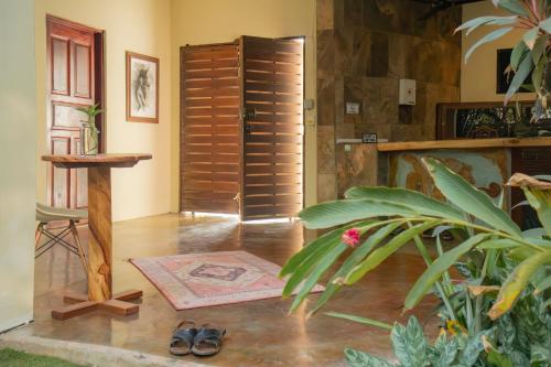 a room with a hallway with wooden shutters and a plant at Punta Dreams in Brisas de Zicatela