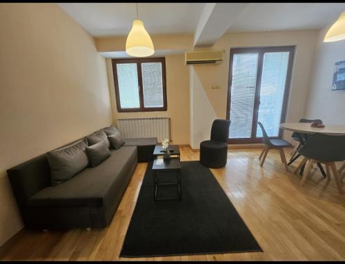 a living room with a couch and a table at Premium 1 One bedroom apartment Maksim Gorki street 8 in Skopje
