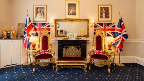 a room with two chairs and a mirror at Jubilee Hotel Victoria in London