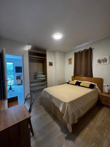 a bedroom with a bed and a desk and a window at Villa Katerinaki in Kos