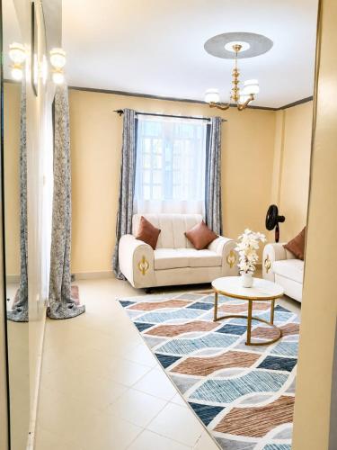 a living room with a couch and a table at Joyland B&B in Mbita