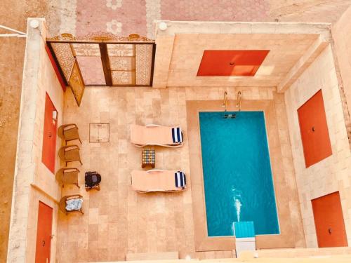 an overhead view of a pool in a building at Djorff Palace - Private villa & swimming pool & central location in Al Aqālitah