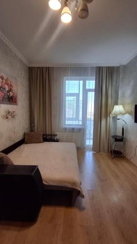 a bedroom with a large bed in a room at See4YOU in Odesa
