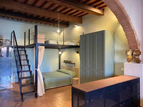 a room with a bunk bed and a ladder at Loft Open Space, Capoliveri Centralissimo in Capoliveri