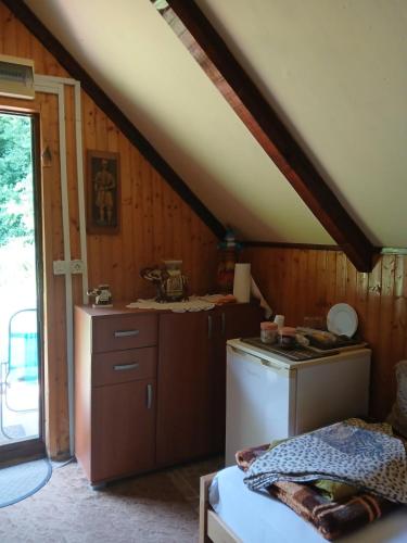 a kitchen with a washer and dryer in a attic at Hidden Nest For Two in Herceg-Novi