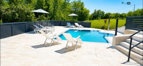 a patio with chairs and a swimming pool at Vikendica Sana in Sanski most
