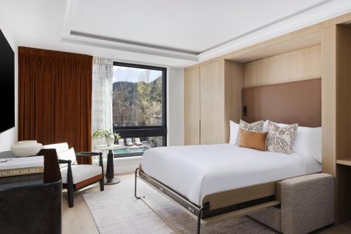 a bedroom with a bed and a large window at White Elephant Aspen in Aspen