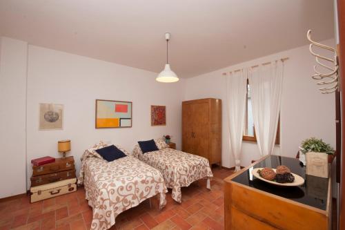 a bedroom with two beds and a television in it at Residenza I Due Mondi in Spoleto