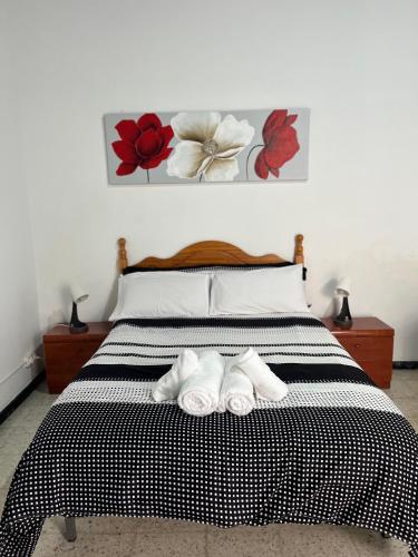 a bedroom with a bed with two towels on it at Casa Vega-Marrero in Arucas