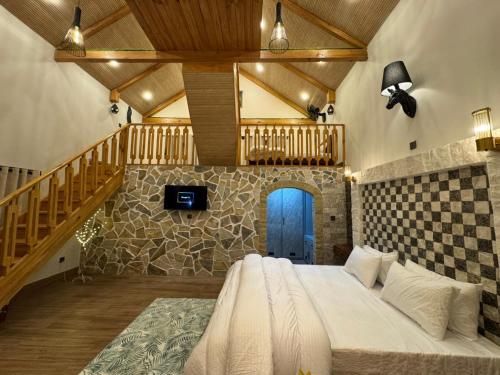 a bedroom with a bed in a room with a staircase at Swiss Chalet Near Murree in Bhāngal