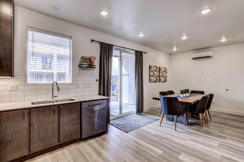 a kitchen with a table and a dining room at Poolside Retreat - King Beds - Dog Friendly in St. George