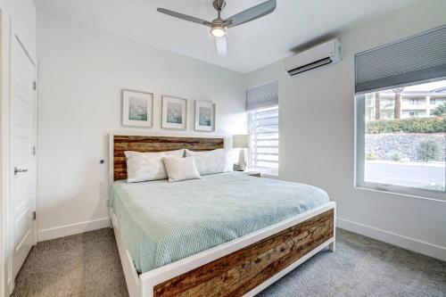 a white bedroom with a bed and a window at Poolside Retreat - King Beds - Dog Friendly in St. George