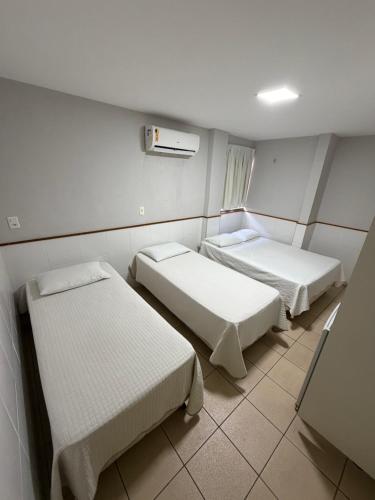 a hospital room with two beds and a window at Hotel Itapoã in Teresina