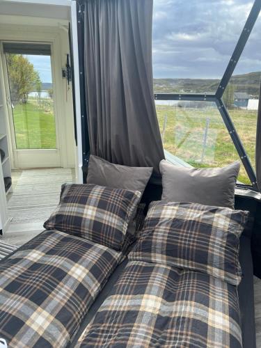 two beds sitting in front of a window at Glassiglo for 2 in Russenes
