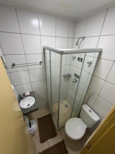 a bathroom with a toilet and a sink at Hotel Itapoã in Teresina