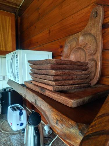 a wooden shelf in a kitchen with a microwave at Las palmas in Costa Azul