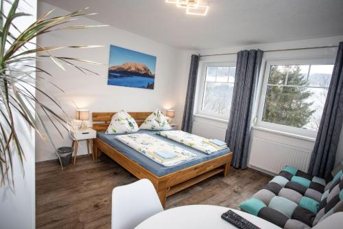 a small room with a bed and a couch at Haus Weisl in Erlsberg