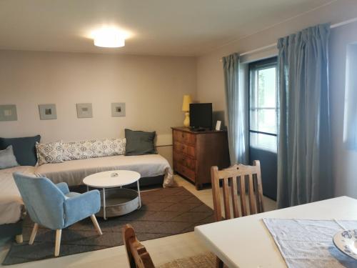 a living room with a bed and a table at Seepark Weiden - Baumhof in Weiden am See