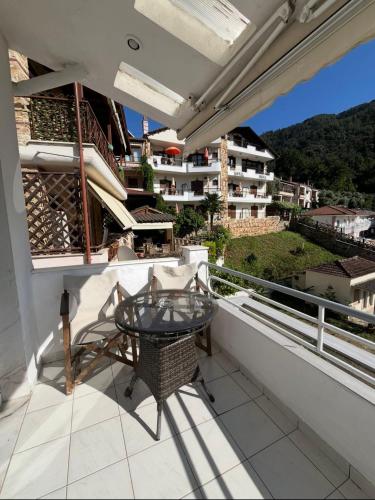 a balcony with a glass table and a view at Villa Apostolidis in Skala Potamias
