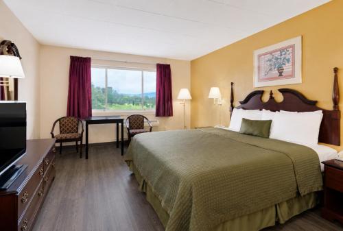 a hotel room with a bed and a desk at Lincoln Way Inn in Chambersburg