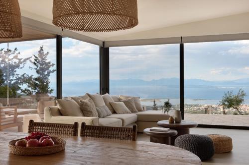 a living room with a couch and a table at Anemones Villas by Omikron Selections in Spanokhórion