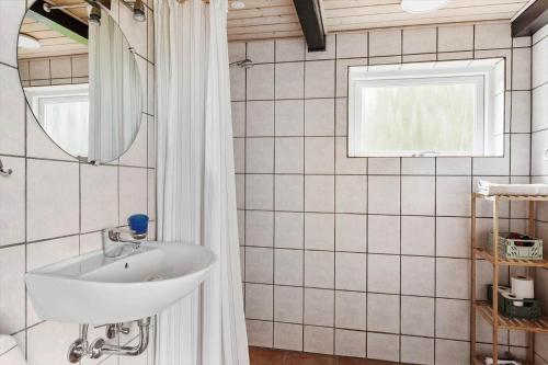 a bathroom with a sink and a mirror at 6707-Ronne-Kallokkevej-5 in Rønne