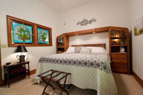 a bedroom with a bed and a chair in it at The Manor at Becks Lake in Rockmart