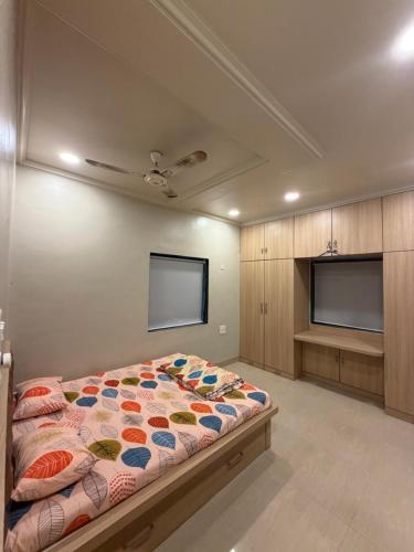 a bedroom with a bed and a flat screen tv at The Highstreet Stay in Pune