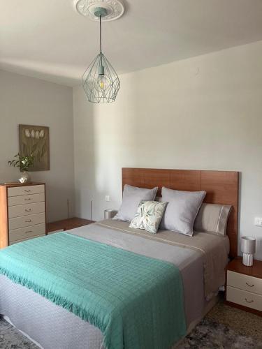 a bedroom with a large bed with a blue blanket at Casa Viñao in Boborás