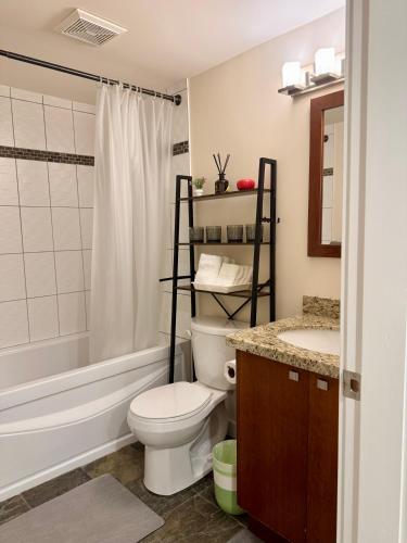 a bathroom with a toilet and a sink and a shower at Ivy s House in West Vancouver
