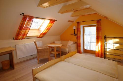 a bedroom with a bed and a desk and a table at Pension MÜLLER - ehemals Pension Wenger in Kirchheim im Innkreis