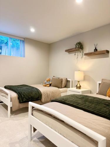 a bedroom with two beds and a window at Ivy s House in West Vancouver
