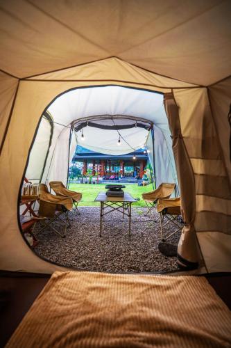 a tent with a table and chairs in it at Ndalem Prabu in Sarangan