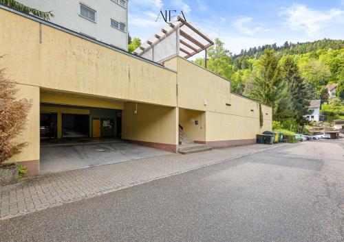a building on a street with a parking lot at ALEA-Apartment - Bad Wildbad in Bad Wildbad