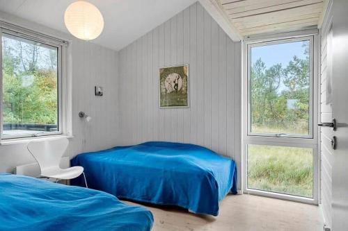a bedroom with two beds and a window at 1077-Thisted-Johns-Vej-33 in Klitmøller