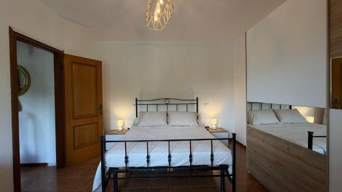 a bedroom with a bed and a chandelier at Casa Irene in Marina di Massa
