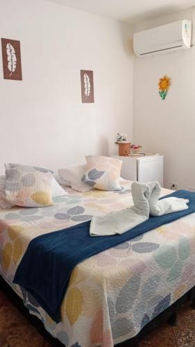 a bedroom with a large bed with pillows on it at Pousada La Floratta in Paulista