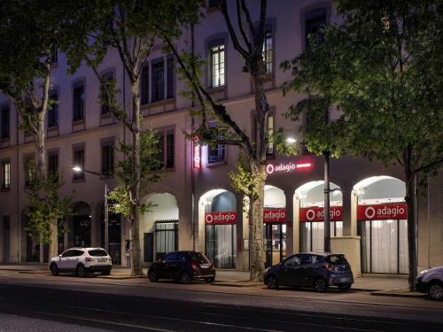 a group of cars parked in front of a building at Aparthotel Adagio Lyon Patio Confluence in Lyon