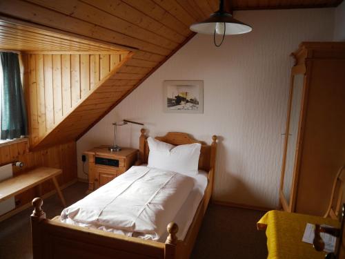 a bedroom with a bed in a attic at Hotel-Gasthof-Destille-Eisenbahn in Mosbach