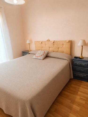 a bedroom with a large bed and two night stands at Barrio Aeropuerto depto 2 dormitorios en Río Grande in Río Grande