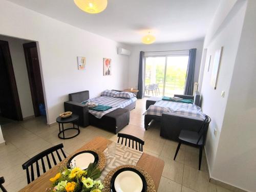 a living room with a couch and a table at Tranquil central apartment in Ampavris