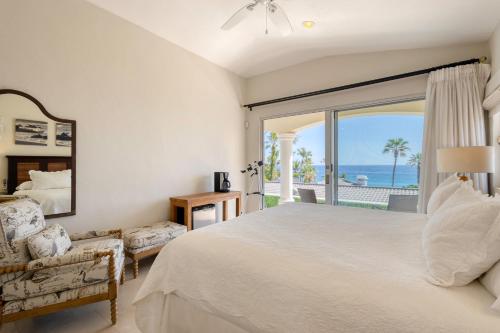 a bedroom with a large bed and a view of the ocean at Casa 4 C's in Cabo San Lucas